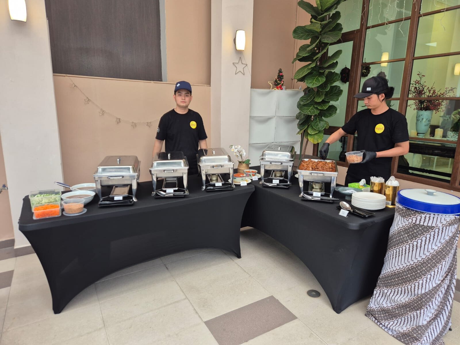 Sabar Menanti crew serving from chafing dishes at a catered event